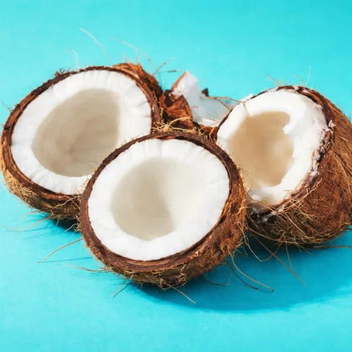 Applying an overnight coconut oil hair mask for deep conditioning and nourishment.