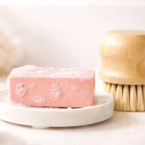 Homemade honey oatmeal soap with pink clay in a soap mold.