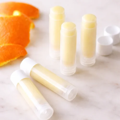 Homemade orange lip balm made with natural ingredients and essential oils.